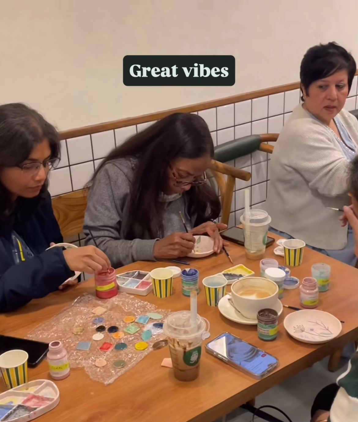 Guests painting ceramic pieces at the mridaceramiq Sip and Paint workshop